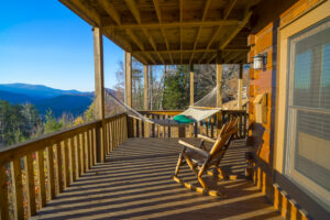 a porch with a hammock and rocking chair, looking out over the mountains in Boone NC